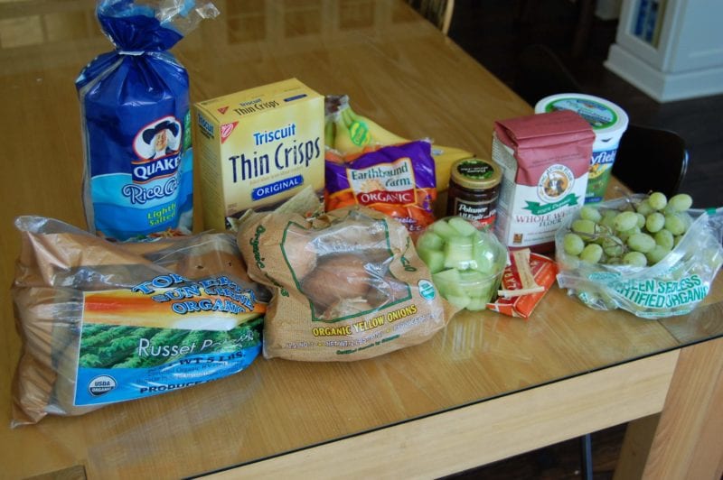 Groceries from Bi-Lo that included potatoes, onions, fruit, crackers, flour, yogurt, Lara bars, and brown rice cakes. 