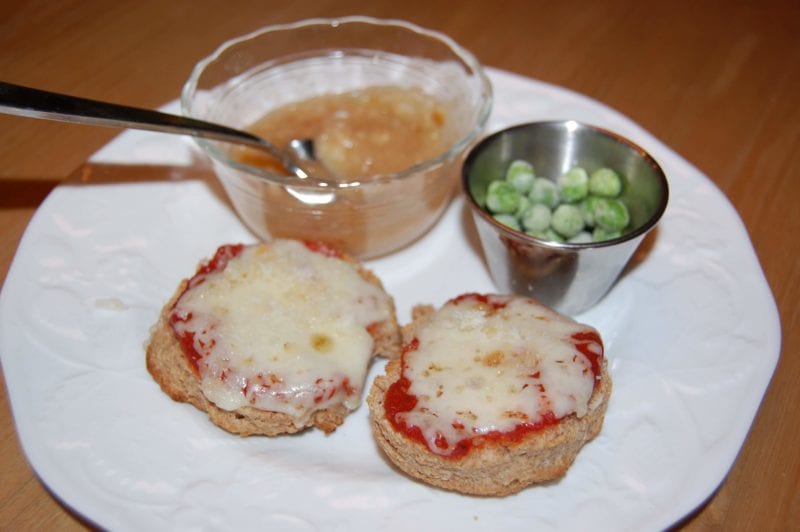 Homemade pizza biscuits, frozen peas, and a side of applesauce. 
