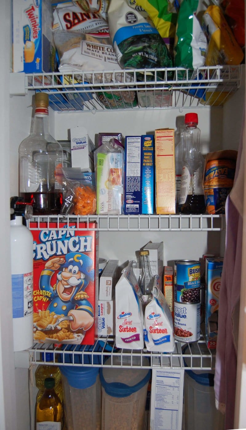 The inside of a kitchen pantry that is full of highly processed food. 