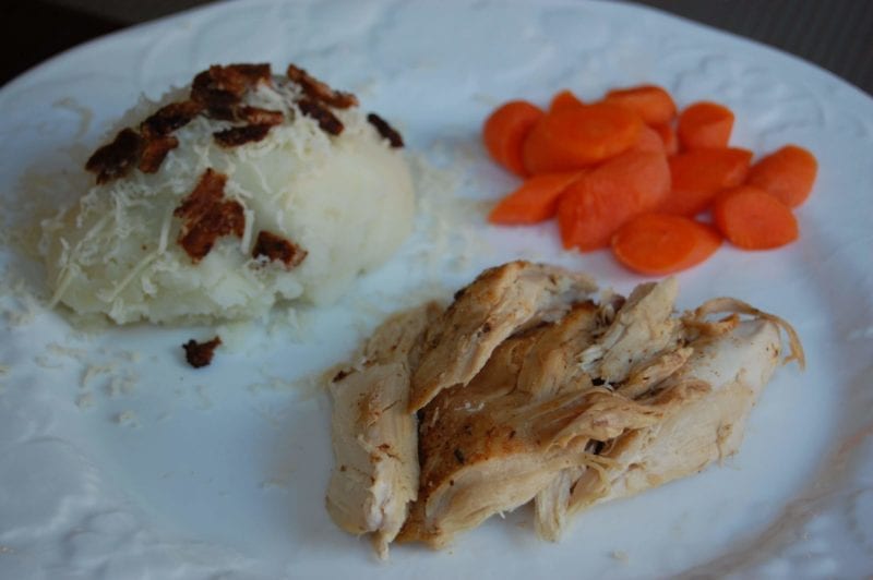 Crockpot chicken, mashed potatoes, and maple glazed carrots on a plate. 