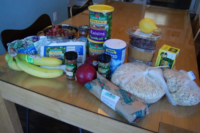 Groceries from Earth Fare that include produce, raisins, frozen blueberries, peanut butter, nuts, fresh flounder, and more. 