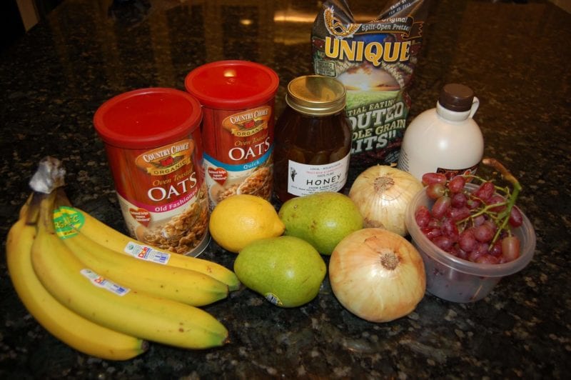 Groceries from Earth Fare that include produce, oats, honey, maple syrup, and whole-grain pretzels. 
