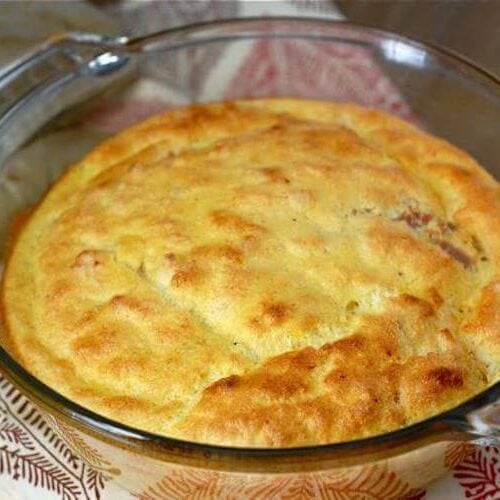A homemade egg souffle in a clear baking dish.