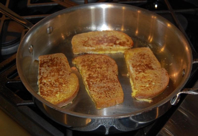 Homemade french toast cooking on the stove. 