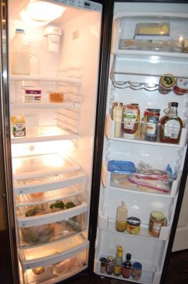 The inside of an almost empty refrigerator. 