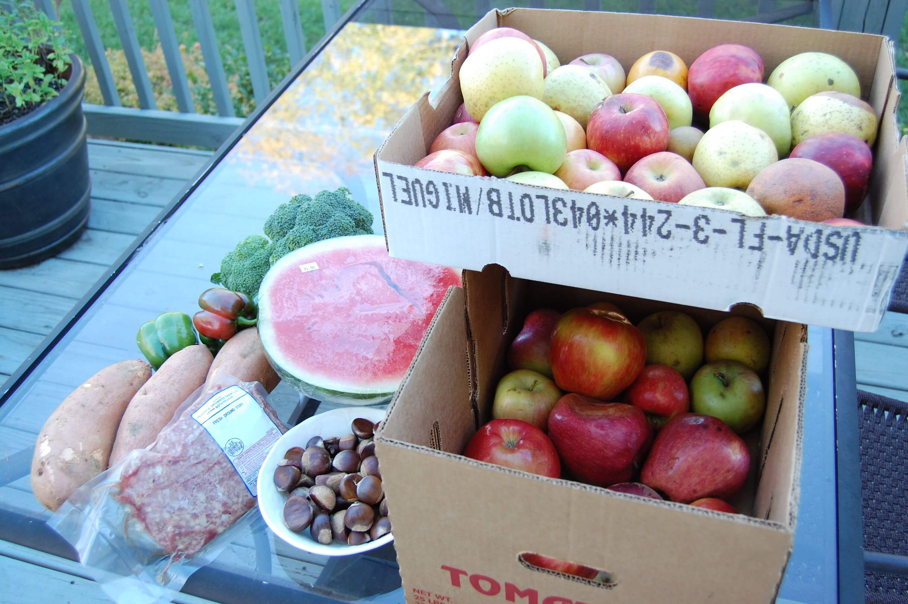 Boxes of apples, watermelon, sweet potatoes, broccoli, meat, and some nuts from the Hillbilly Produce in North Carolina. 