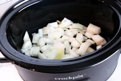 Chopped onion inside a slow cooker