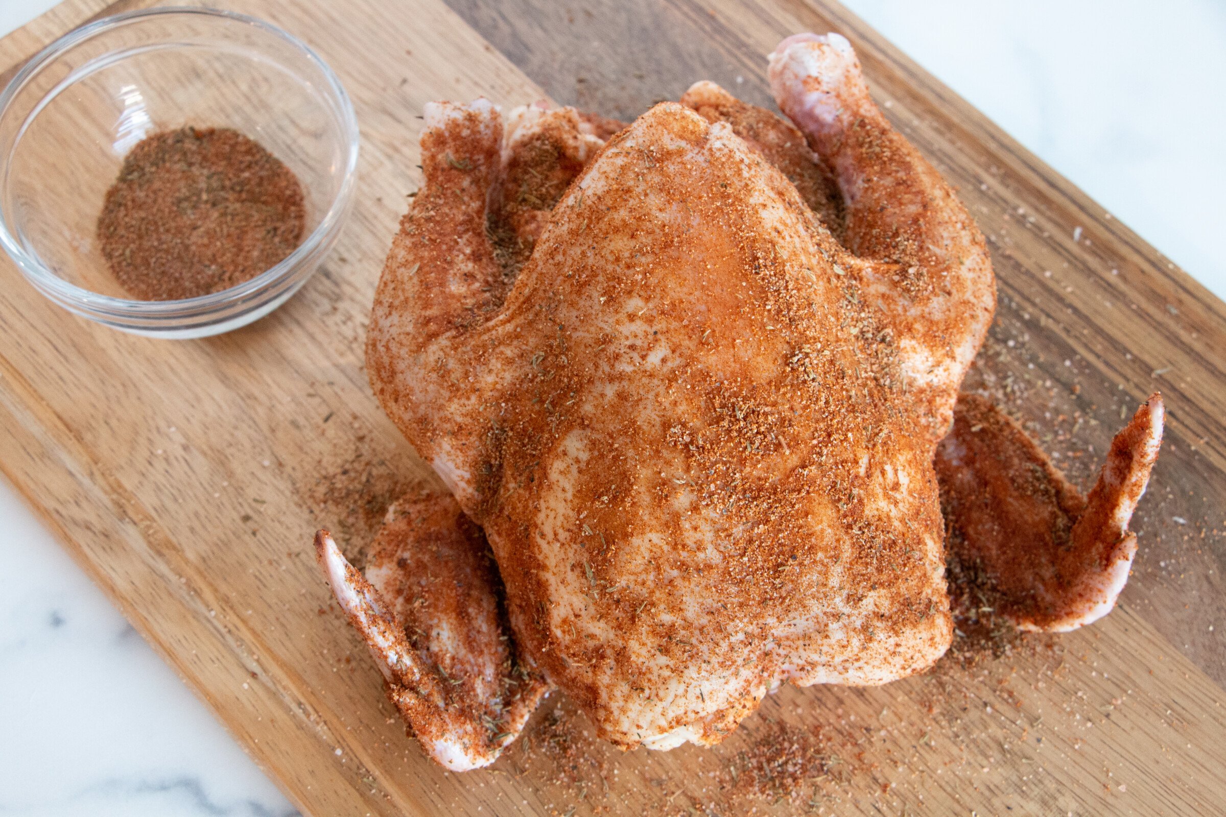Whole chicken rubbed with rotisserie style spices. It is ready to be added to a crock pot.