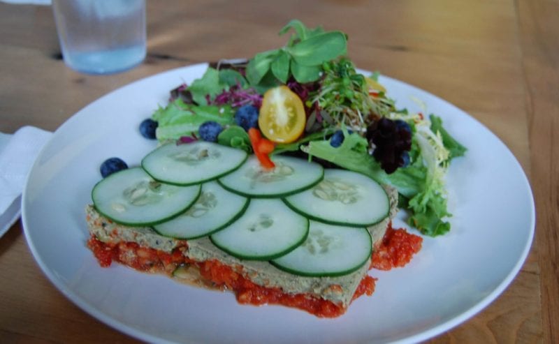 Vegan lasagne served with cucumbers and a side salad at Luna's Living Kitchen in Charlotte, NC. 