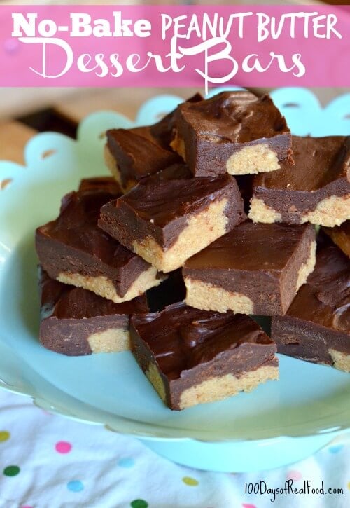 A large pile of No-Bake Peanut Butter Dessert Bars stacked on a teal plate.