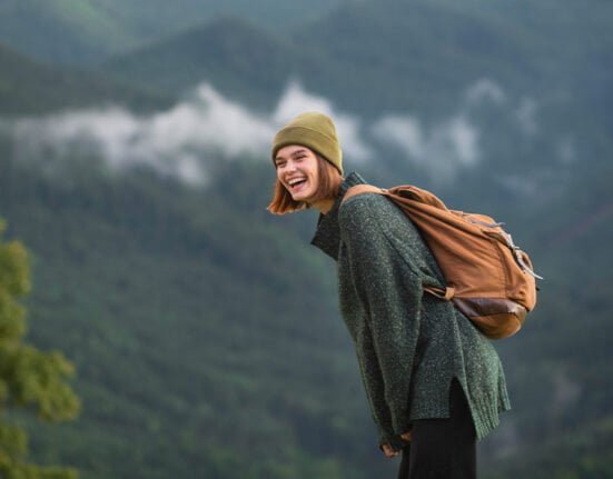 A girl feeling happy in the mountains