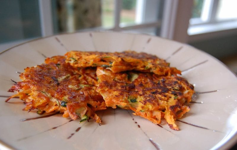 Potato pancakes made with sweet potato and shredded zucchini on a plate. 