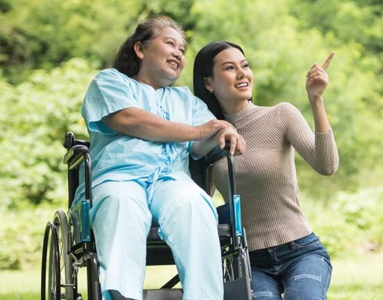 A lady on wheelchair with a girl