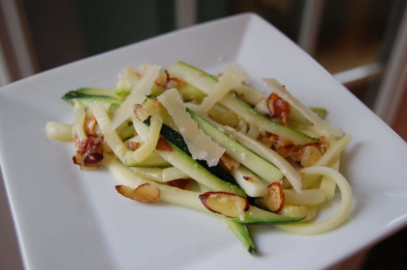 Zucchini noodles with sliced almonds and cheese. 